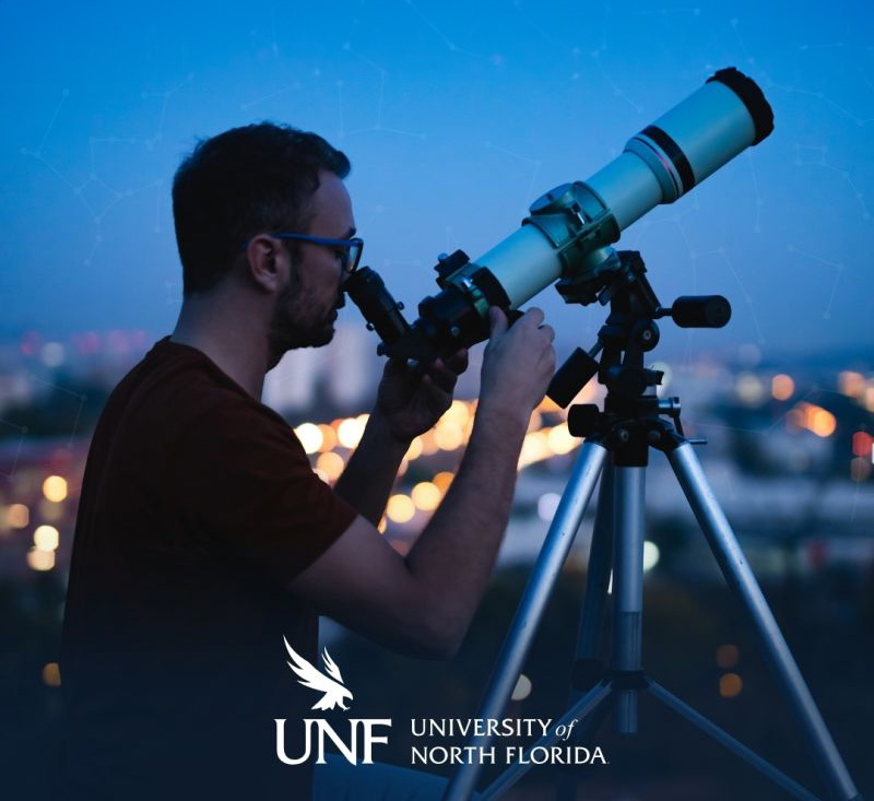 Man standing on a rooftop looking through a telescope, University of North Florida logo