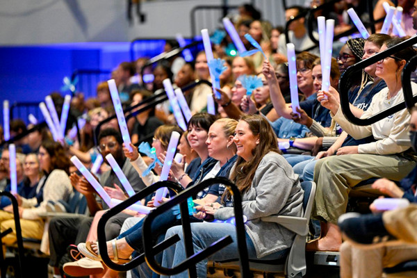 UNF employees cheering in the audience at Convocation 2026