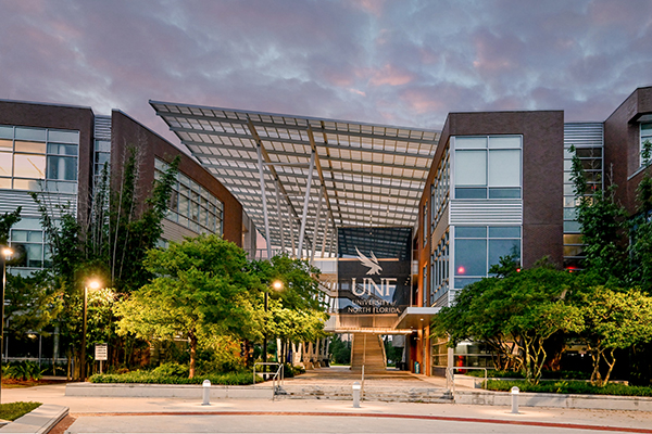 UNF student union building with sun rising behind it