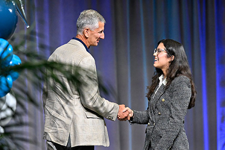 UNF BOT Chair Steve Moore and UNF student Valentina Bonilla shaking hands at Convocation 2026