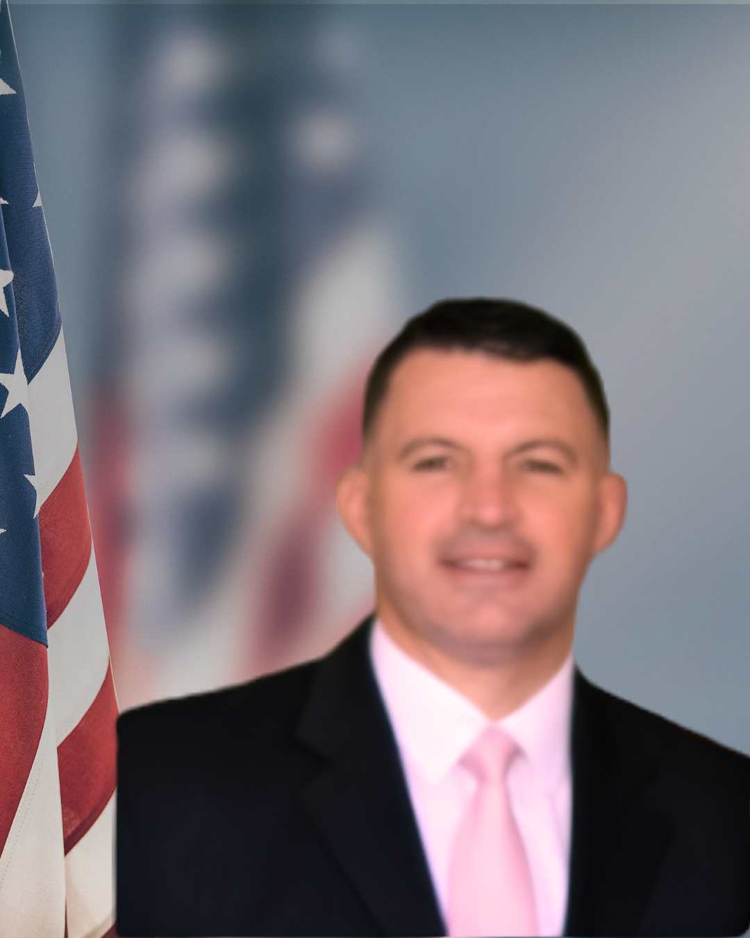 Picture of the MVRC director, Jim Riley. Male in a suit.