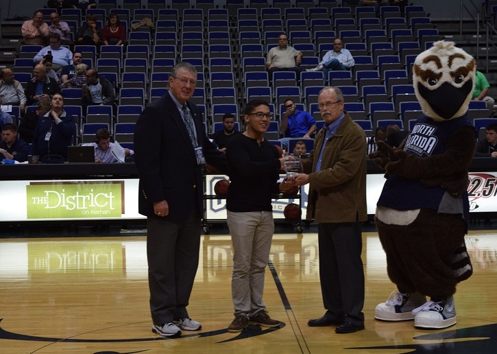 Two men and Ozzy the Osprey presenting Ramses with his award