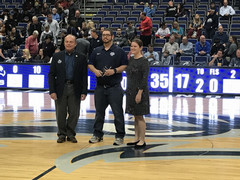 Ryan and two other people standing at half court in the arena