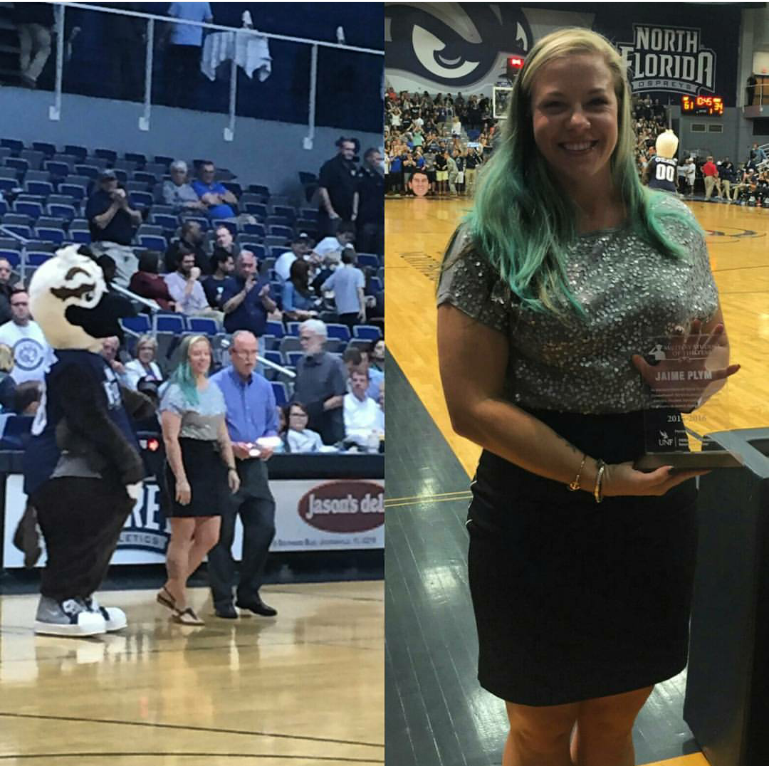 Jaime walking out to half court at the arena and holding her award