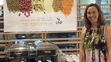 UNF dietician standing in front of the nutrition study display table