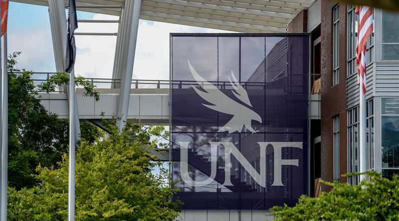 Large blue UNF banner hanging in the student union plaza