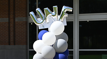Balloons spelling UNF in silver letters