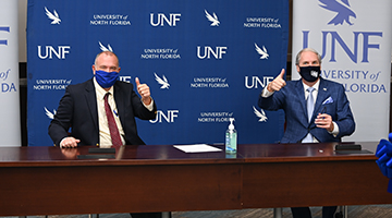 UNF President Szymanski signing MOU with Daytona College President
