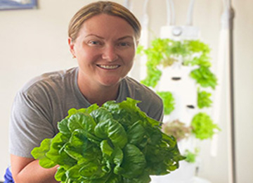 UNF Wellness Dietitians Kelly Schooley holding leafy greens