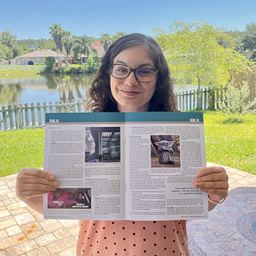 Maria Atilano holding a copy of the May/June 2021 issue of Marketing Library Services