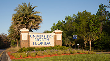 UNF entrance sign at sunset