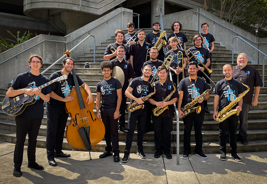 UNF Jazz Ensemble students standing with their instruments on an outdoor staircase