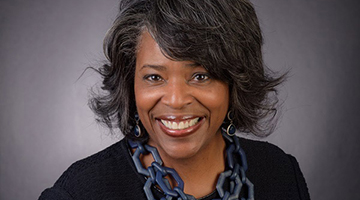 Headshot of Dr. Olenda E. Johnson on a gray background