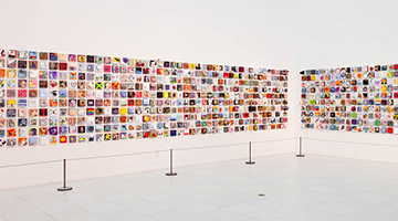 2011 Imagination Squared installation featuring five-by-five inch canvases hung on a white wall