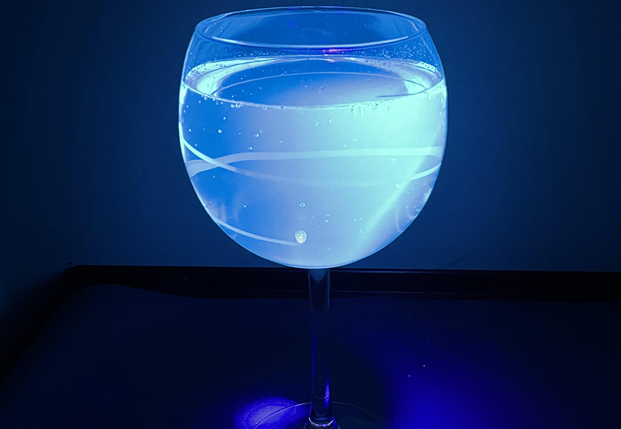 Glowing drink is tonic water as seen with a black light