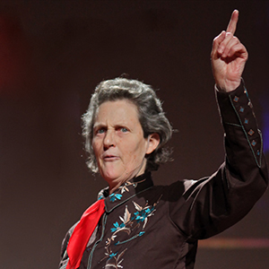 temple grandin at a talk holding up her arm