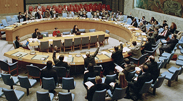 Photo credit goes to the United Nations. Soderberg is second delegate sitting at table with arm raised during yes vote.