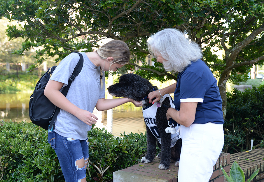 OspreyPERCH student with a faculty member and a service dog