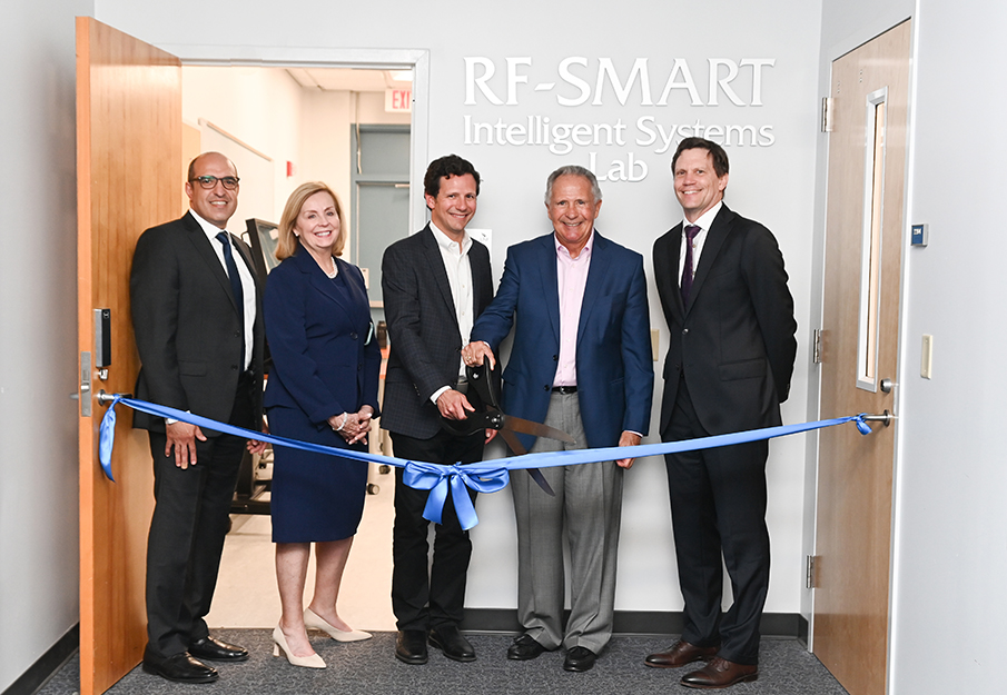UNF and CCEC leadership cutting a blue ribbon to open the RF-SMART Lab
