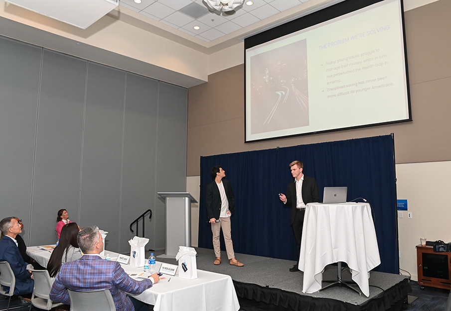 Two Coggin students presenting a powerpoint