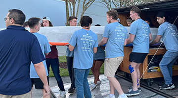 Florida A-and-M University team carrying out their concrete canoe