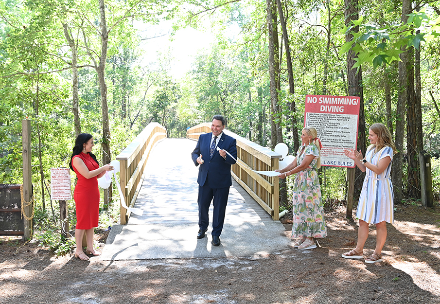 President Limayem cutting the ribbon at the opening ceremony at the restoration of the EcoAdventure bridge