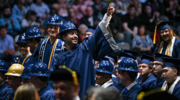 CCEC graduate celebrating graduating wearing his helmet