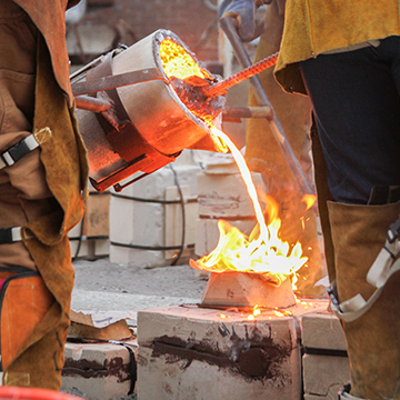 Students pouring melted iron