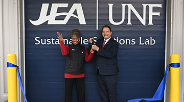 UNF President Moez Limayem and JEA Chief Operating Officer Raynetta Curry Marshall cutting ribbon at new Sustainable Solutions Lab