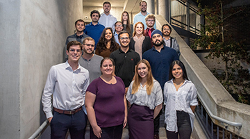 The First graduating class for the Masters of Business and Analytics Program standing together on staircase