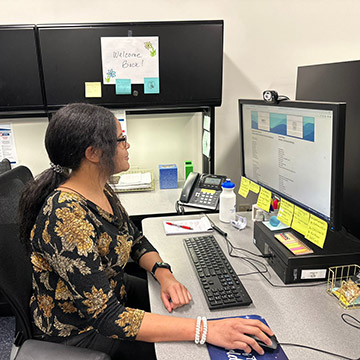 Moyra working on analytics on a computer in the SBDC