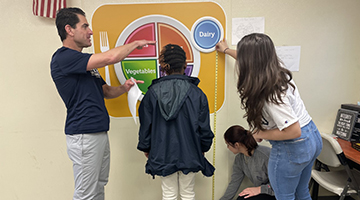 Nourish to Flourish volunteers measuring child