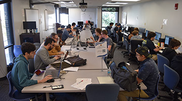 UNF students sitting at their computers creating programs
