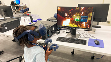 Ozzie Day Camp camper playing with a VR headset