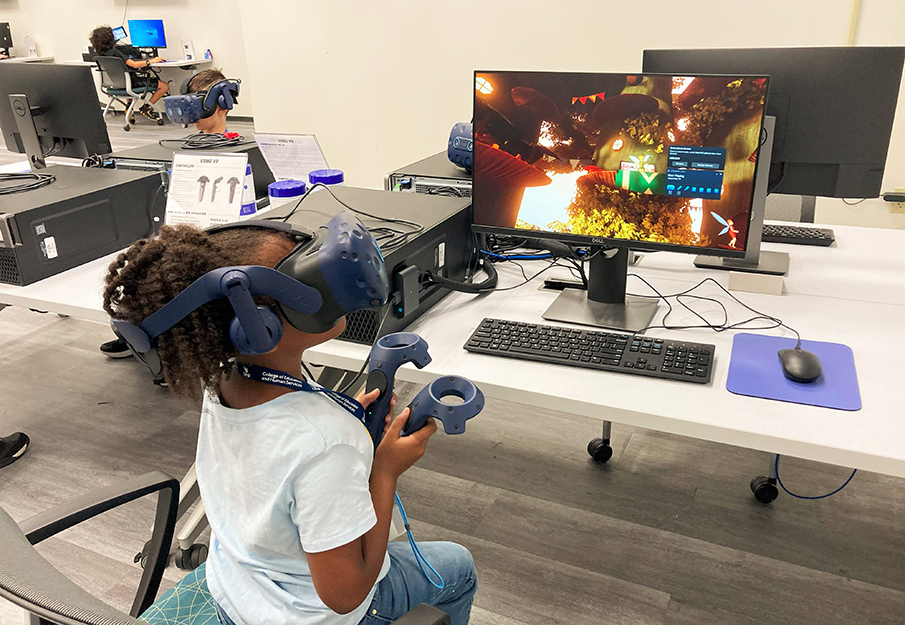 Ozzie Day Camp camper playing with a VR headset