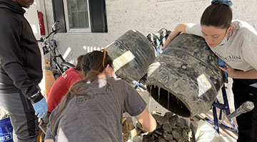 Students pouring oysters out of a barrel