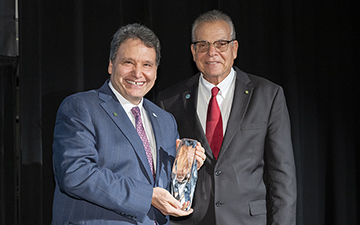 UNF President Moez Limayem accepting an award