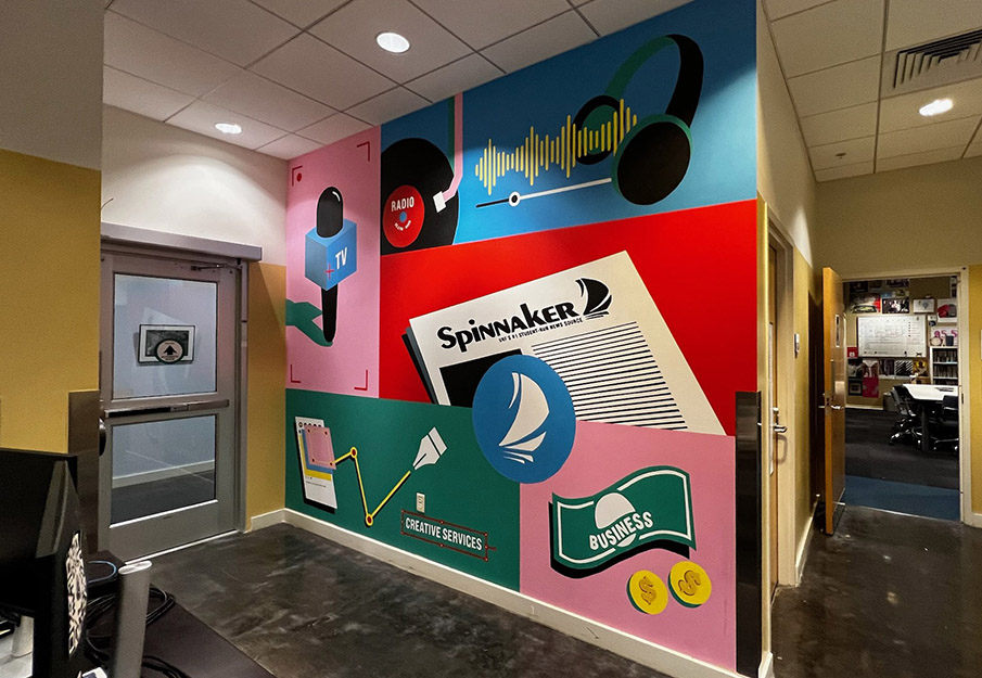 The wall at the entrance of Spinnaker full of bright colors and news symbols