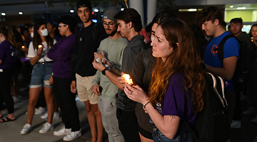 Girl holding candle while facing forward at Take Back the Night event