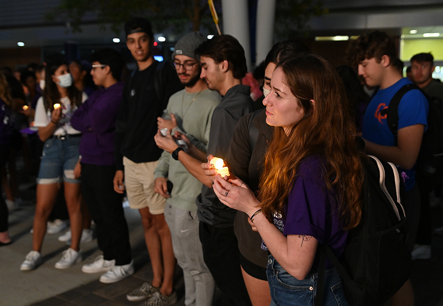 Girl holding candle while facing forward at Take Back the Night event