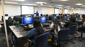 Students in cybersecurity camp listening to professor