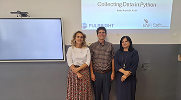 Blake Rayfield standing with two women after presenting
