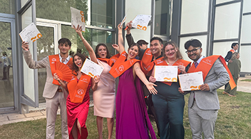 Carmen Rodriguez and friends holding up their degrees at the University of Valencia commencement