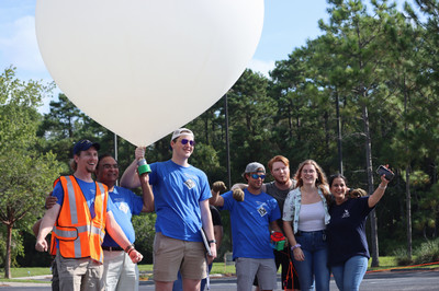 UNF Colin Ott with research team holding NASA balloon
