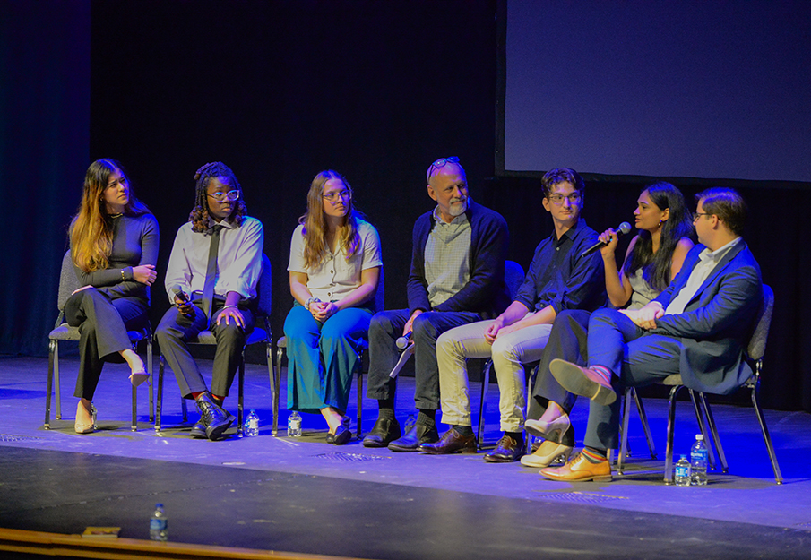 Student panel and UA professor Ted McLoof sitting on stage