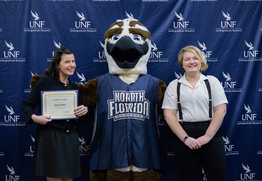 Dr. Jenny Stuber, Ozzie and UNF student at research conference