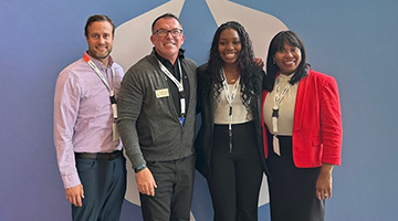 Award winners posing in front of a FranklinCovey sign