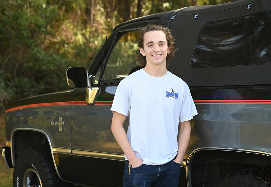 UNF student Hunter Ford standing in front of his truck