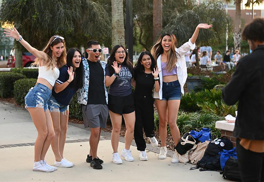 Group of UNF students jumping in excitement at Homecoming Pep Rally 2023