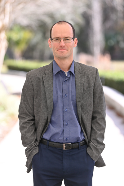 Igor Tavuzhnyanskiy standing outside of Hicks Hall on UNF campus